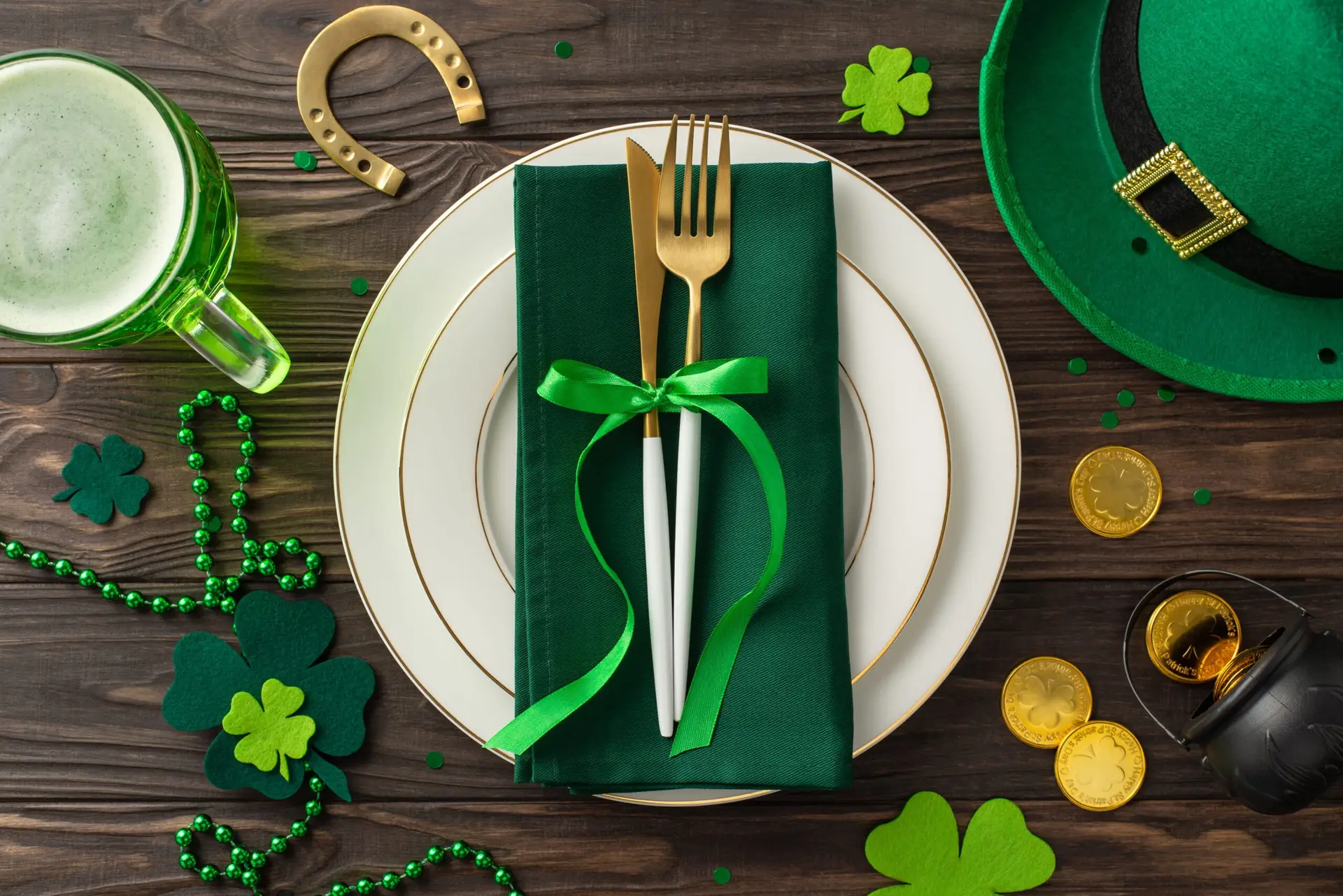 Festive St. Patrick's Day table with green decorations and shamrocks.